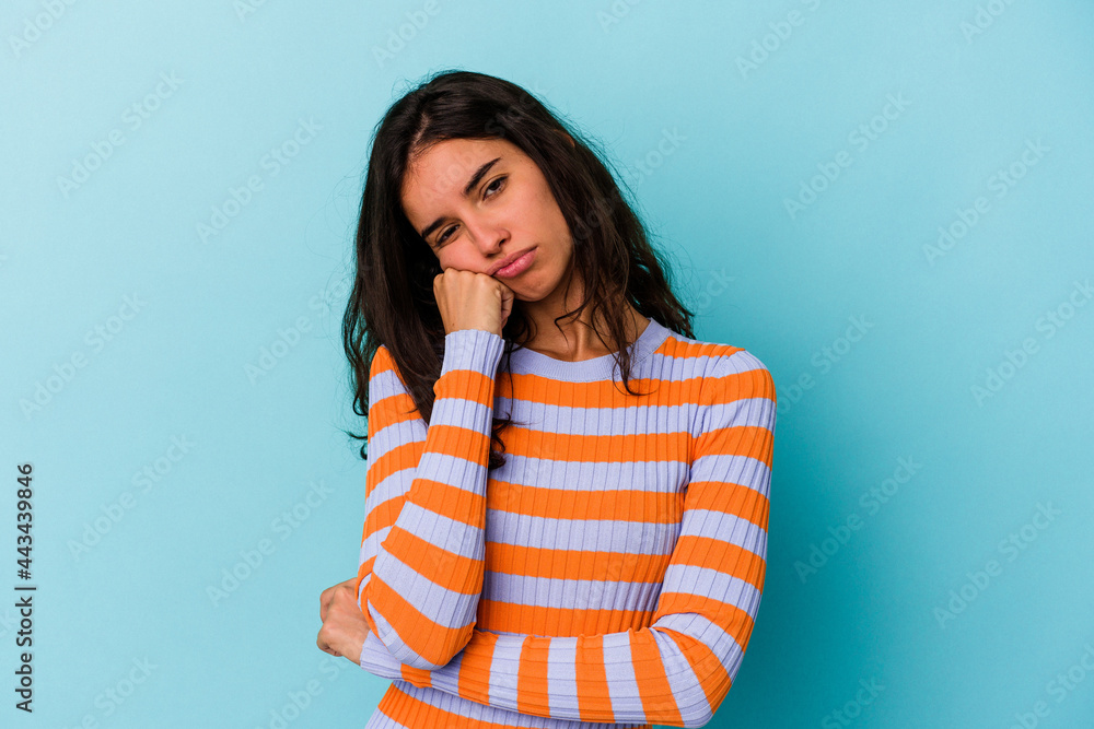 Young caucasian woman isolated on blue background who feels sad and pensive, looking at copy space. Young caucasian woman isolated on blue background who feels sad and pensive, looking at copy space.