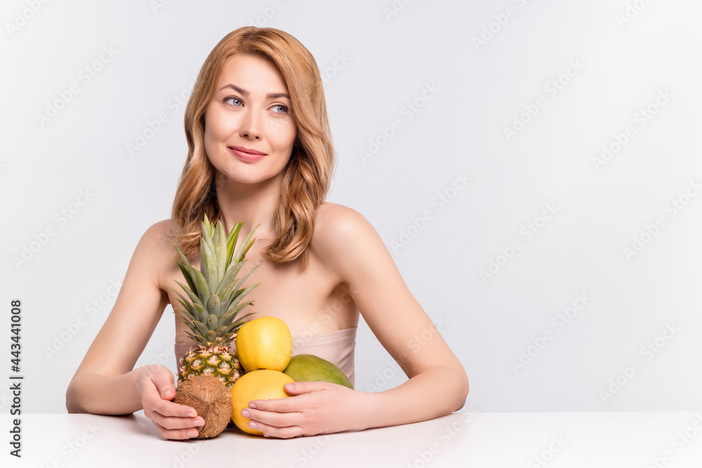 Portrait of attractive dreamy woman holding citrus fruits copy space vegan weight loss menu isolated over grey pastel color background Portrait of attractive dreamy woman holding citrus fruits copy space vegan weight loss menu isolated over grey pastel color background