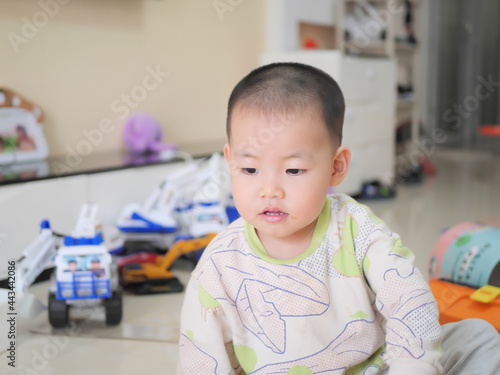 Chinese little boy playing with toys on the living room floor