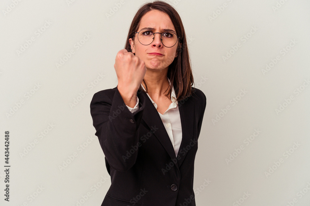 Young business woman isolated on white background showing fist to camera, aggressive facial expression. Young business woman isolated on white background showing fist to camera, aggressive facial expression.