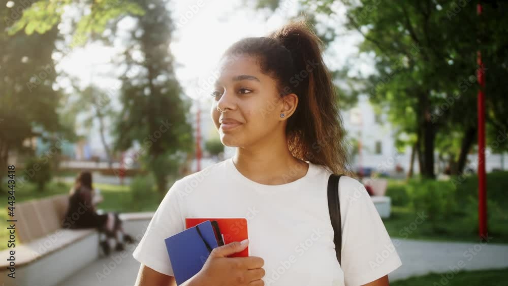 Portrait of a smiling African American student girl with books. Portrait of a smiling African American student girl with books.