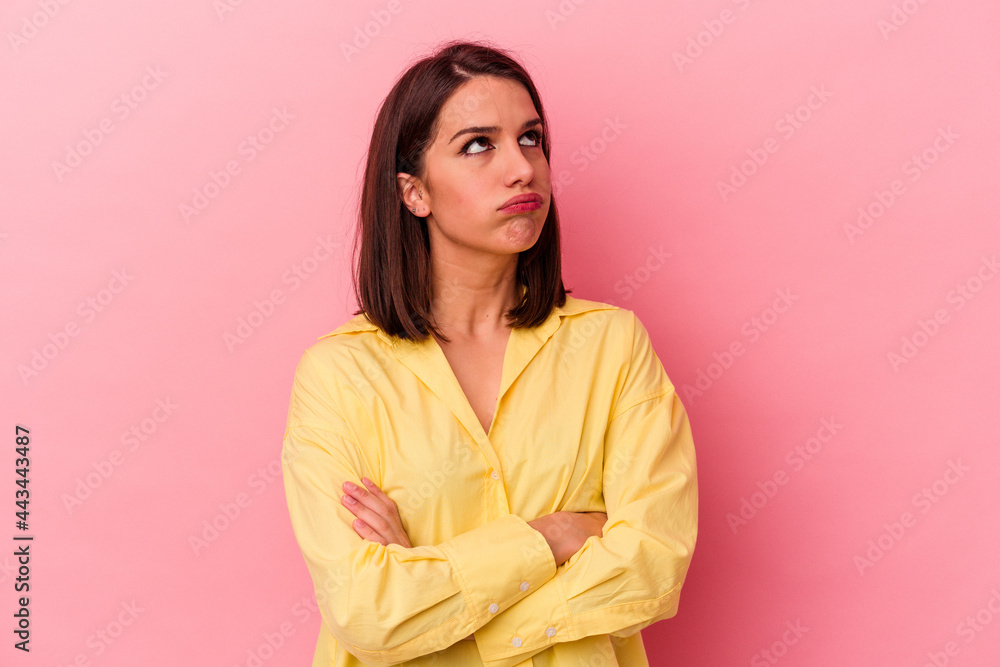 Young caucasian woman isolated on pink background tired of a repetitive task. Young caucasian woman isolated on pink background tired of a repetitive task.