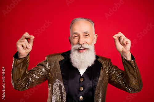 Photo of funny white beard aged comic man dance wear gold suit isolated on red color background