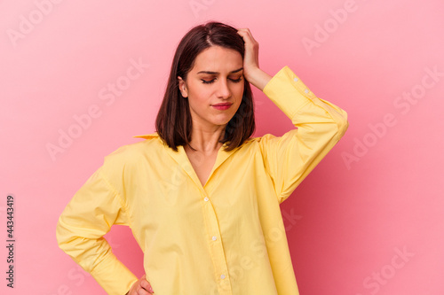 Young caucasian woman isolated on pink background tired and very sleepy keeping hand on head.