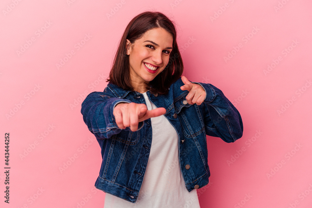 Young caucasian woman isolated on pink background cheerful smiles pointing to front. Young caucasian woman isolated on pink background cheerful smiles pointing to front.