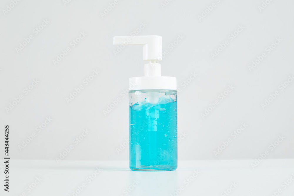 Close-up, blue alcohol in a clear plastic bottle on white background used to clean hands to prevent the spread of disease and infection of coronavirus (Covid-19) bacteria and for good health hygiene. Close-up, blue alcohol in a clear plastic bottle on white background used to clean hands to prevent the spread of disease and infection of coronavirus (Covid-19) bacteria and for good health hygiene.