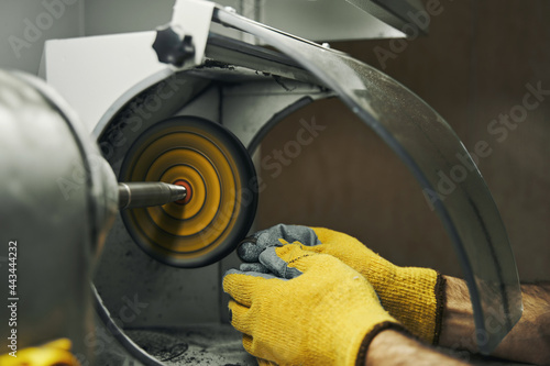 Abrasive wheel grinder used for polishing silver ring photo