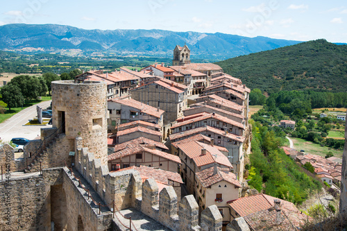 Castle towerat Frias and battlements, with the village and mountains in the background. Frias, Burgos, Merindades, Spain , Europe photo