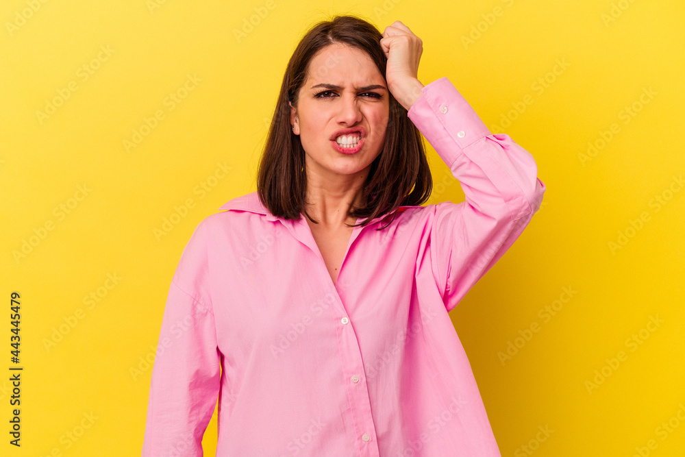 Young caucasian woman isolated on yellow background forgetting something, slapping forehead with palm and closing eyes. Young caucasian woman isolated on yellow background forgetting something, slapping forehead with palm and closing eyes.