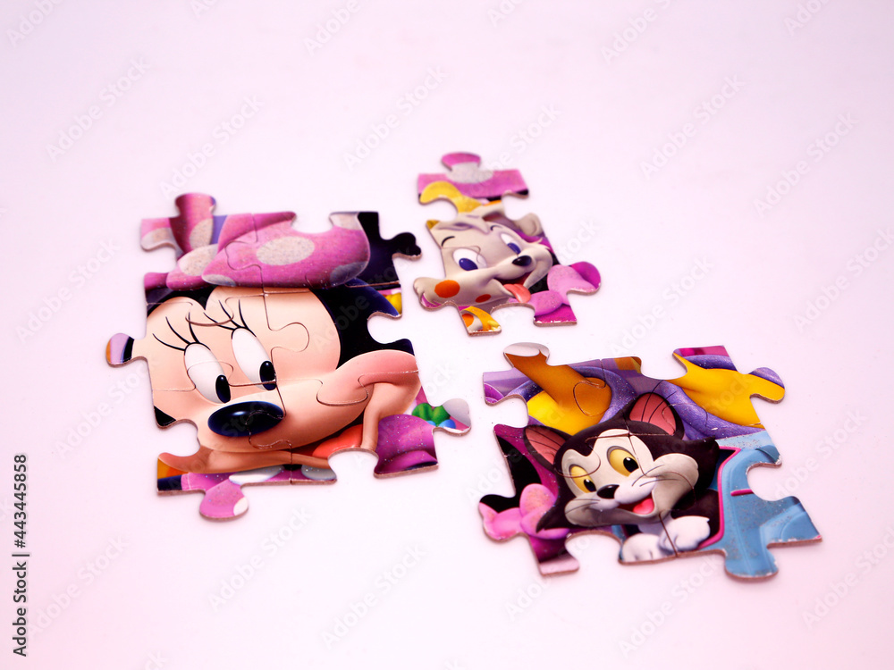 Puzzle pieces of Minnie Mouse and her cat Figaro and her dog. Minnie Mouse board game. Toy
