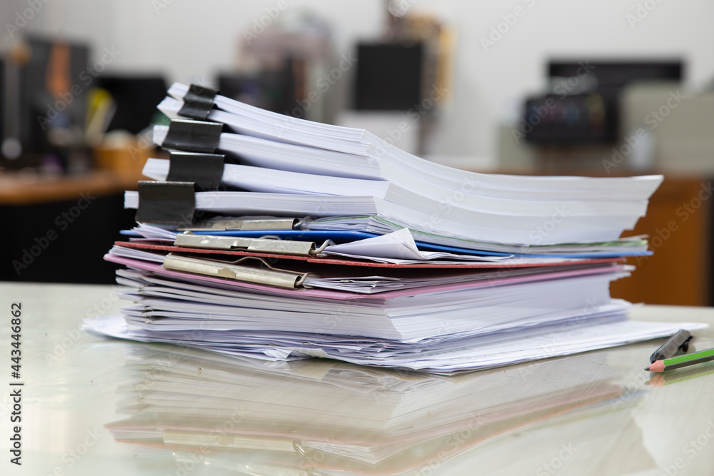 Pile of unfinished documents on office desk, Stack of business paper Pile of unfinished documents on office desk, Stack of business paper