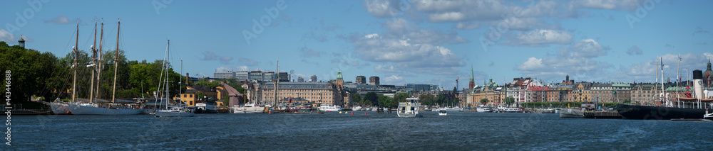 Morning view of the district Östermalm at the bay Ladugårdsviken, commuting boats and an old wood dolphin in the harbor of Stockholm
