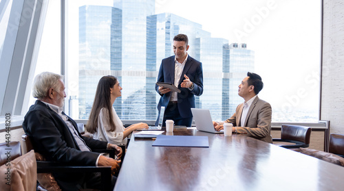 Businessman taking to business team in meeting room at office. Group of businesspeople talking  discussing about the scheme for investment in office. business   people  teamwork and brainstorming