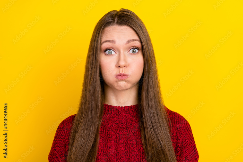 Portrait of attractive funny playful girlish long-haired girl holding breath fooling isolated over vibrant yellow color background Portrait of attractive funny playful girlish long-haired girl holding breath fooling isolated over vibrant yellow color background