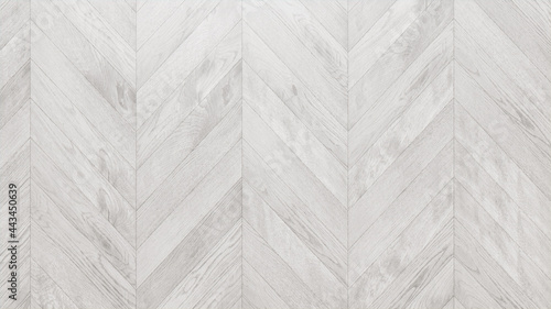 White Wood Background. Wooden Boards arranged in a Chevron Parquet Pattern.