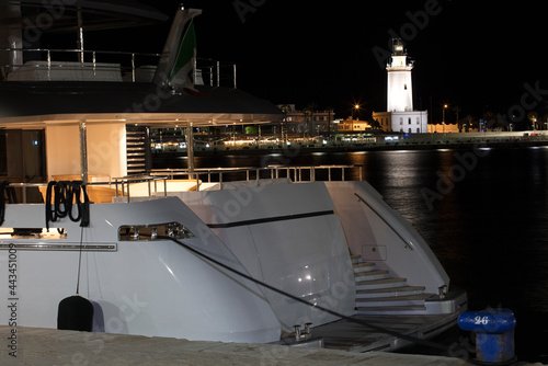 Yachts with Lighthouse of Malaga in the background