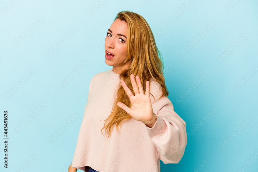 Fototapeta premium Caucasian woman isolated on blue background being shocked due to an imminent danger