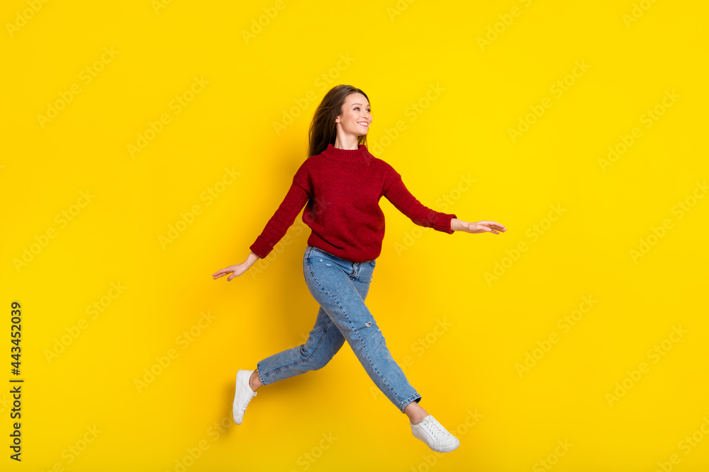 Full body profile side photo of young attractive woman happy positive smile jump go walk isolated over yellow color background