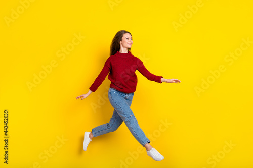 Fototapeta Naklejka Na Ścianę i Meble -  Full body profile side photo of young attractive woman happy positive smile jump go walk isolated over yellow color background