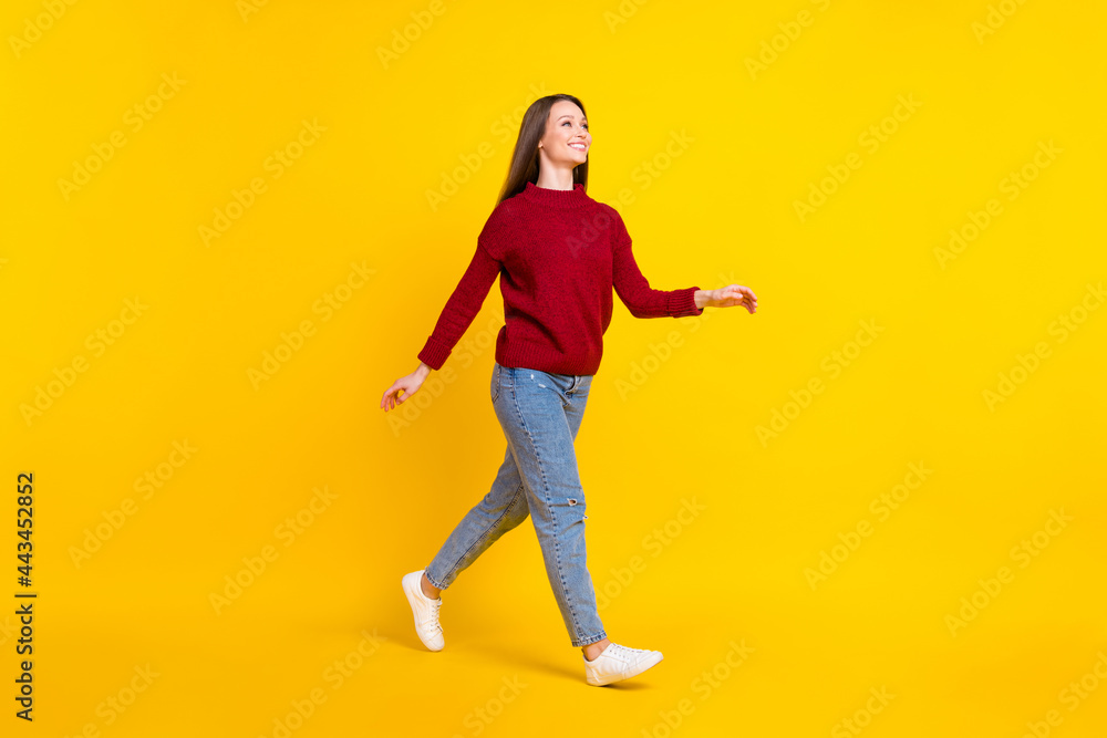 Fototapeta premium Full length body size view of attractive cheerful girl walking strolling isolated over bright yellow color background