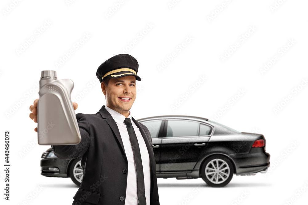 Professional chauffeur in a uniform holding a bottle of motor oil in front of a black car Professional chauffeur in a uniform holding a bottle of motor oil in front of a black car