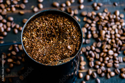 Coarsely Ground Coffee Beans in a Grinder: Coffee grounds in an electric coffee grinder