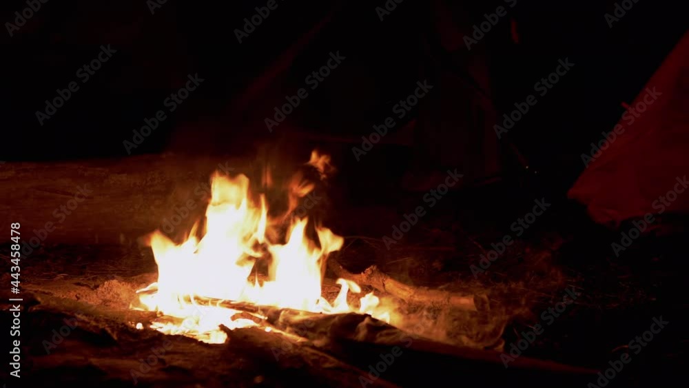 Night Bright Bonfire Burns Against Background of Tourist Tents in