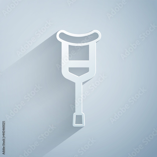 Paper cut Crutch or crutches icon isolated on grey background. Equipment for rehabilitation of people with diseases of musculoskeletal system. Paper art style. Vector