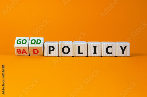Good or bad policy symbol. Turned wooden cubes, changed words 'bad policy' to 'good policy'. Beautiful orange table, orange background. Business, bad or good policy concept. Copy space.