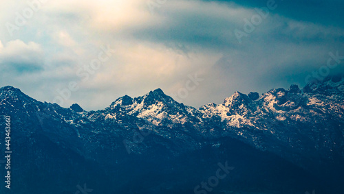 himalayan snow cape mountains with dramatic sky at evening