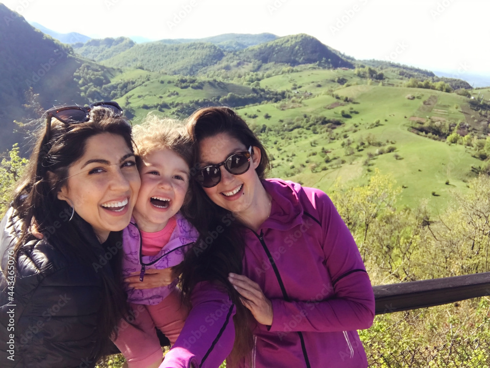 Happy Family with  Kid in the Spring Mountain  .Family Portrait of Mother ,Daughter and Aunt .