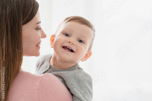 Toothy smile of a little small kid child, embracing his mother nanny babysitter. Happy moments of motherhood. Adoption vitro IVF concept photo