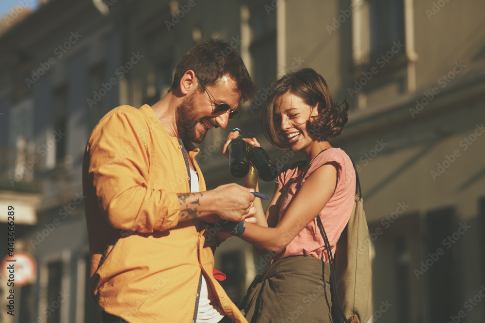 Fototapeta premium Young happy couple having fun on the street during a summer day