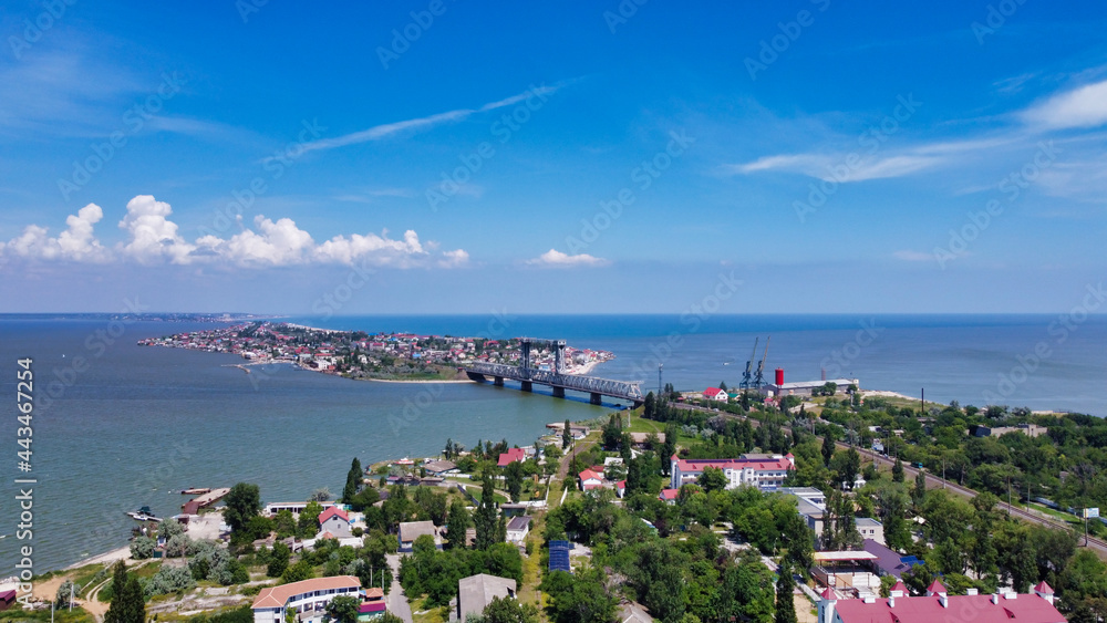 Obraz premium View of the Black Sea and railroad bridge. in Zatoka. Houses on the peninsula and estuary. Ukraine. Europe