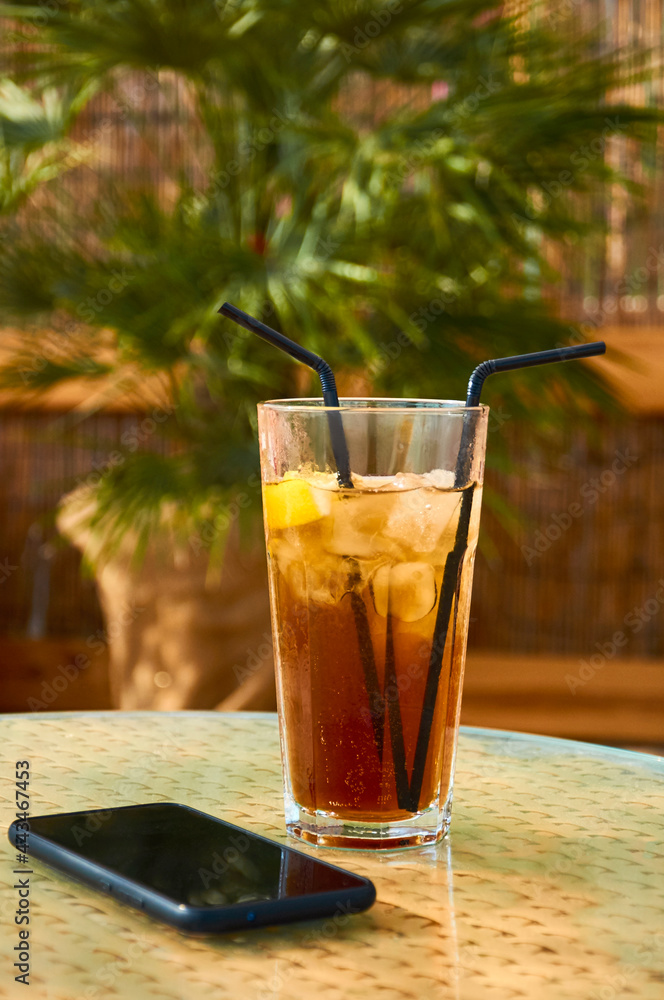 Cold drink cocktail and telefon on the table. Summer rest Cold drink cocktail and telefon on the table. Summer rest