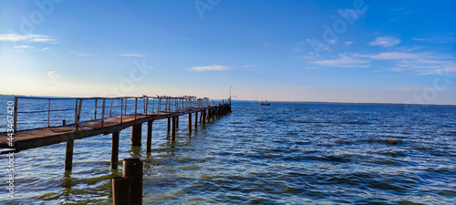 View of the old iron rusty pier in the estuary. Blue sky and water in Zatoka. Ukraine. Europe © Pavlo