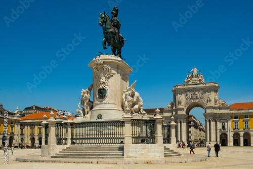 Beautiful image of the gate and landmark statue of King Jose on the Commerce square (Praca do Comercio) in Lisbon, Portugal with blus sky during tourist season