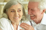 Close up portrait of cheerful senior couple at home