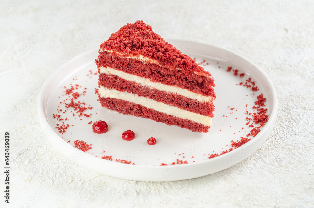 Red velvet cake. Piece on a white plate. Garnished with crumbs and  cranberry sauce. Light background. Stock-Foto | Adobe Stock