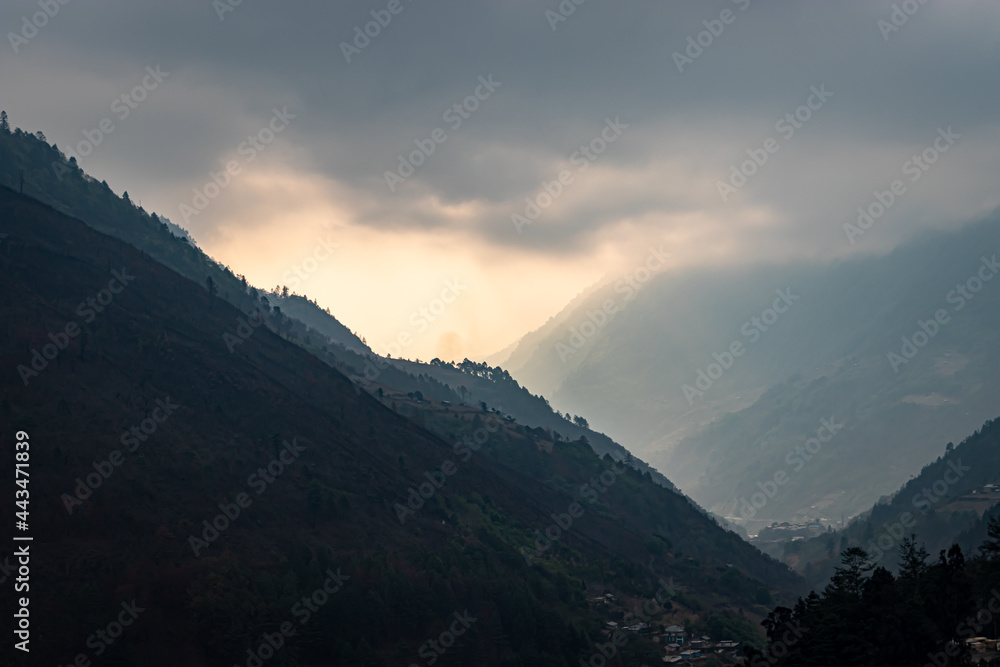 mountain valley with dramatic sky at morning from flat angle