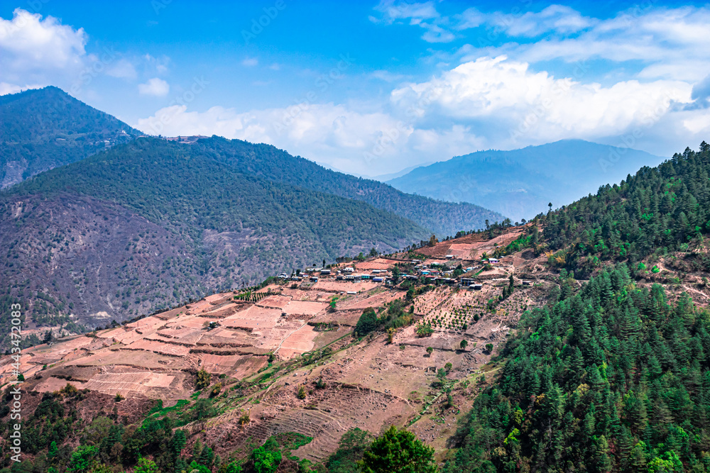 mountains with paddy fields and remote village at morning