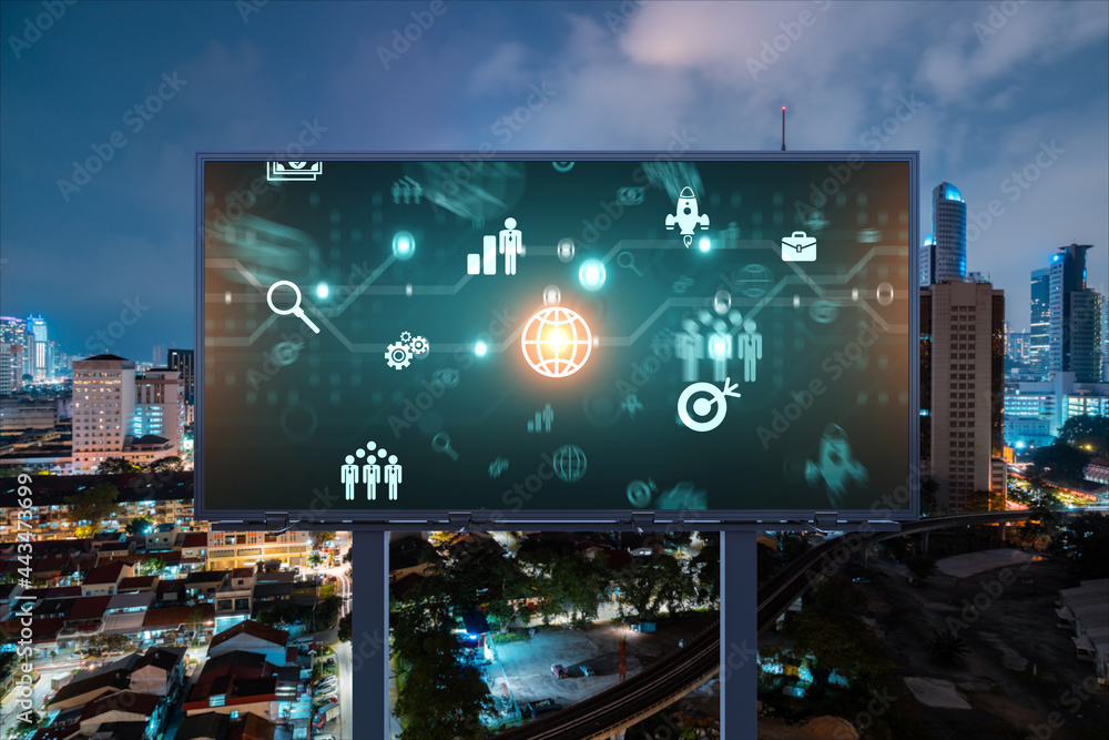 Research and technological development glowing icons on billboard. Night panoramic city view of Kuala Lumpur. Concept of innovative activities expanding new services or products in Malaysia, Asia. Research and technological development glowing icons on billboard. Night panoramic city view of Kuala Lumpur. Concept of innovative activities expanding new services or products in Malaysia, Asia.