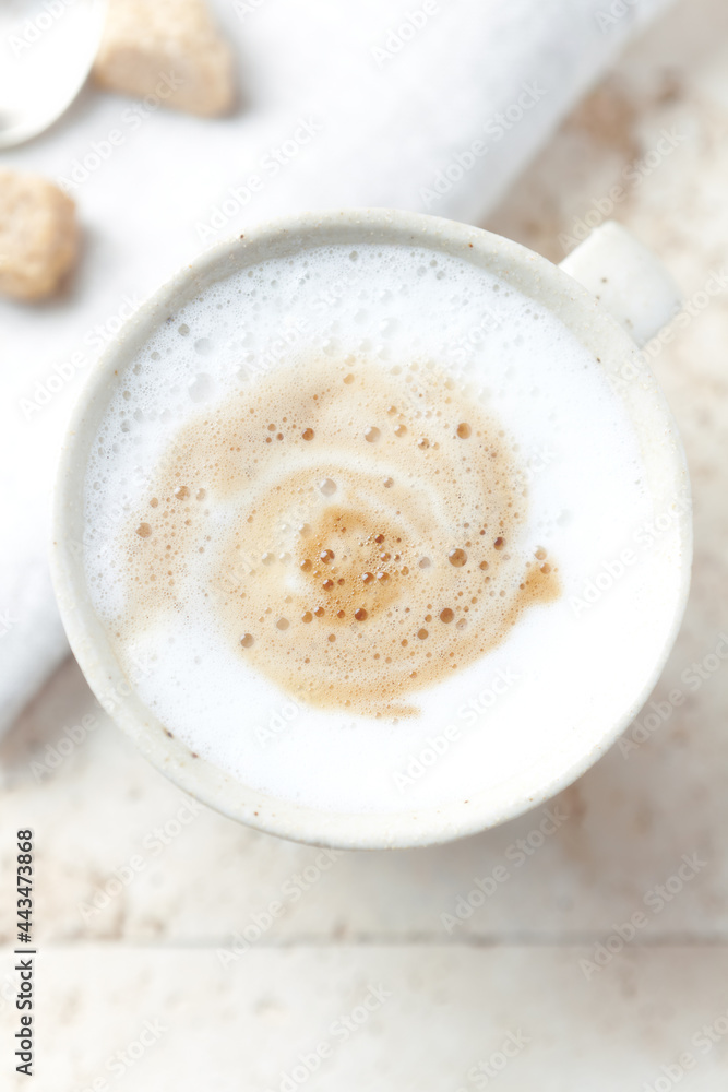 Coffee with milk on bright stone background. Top view. Close up. Coffee with milk on bright stone background. Top view. Close up.