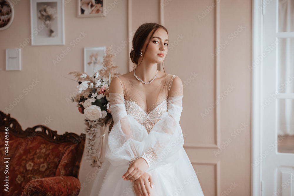 Beautiful bride with light make-up in white dress in an exquisite interior Beautiful bride with light make-up in white dress in an exquisite interior