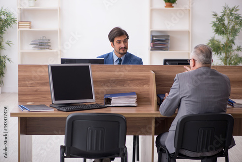 Two male employees working in the office