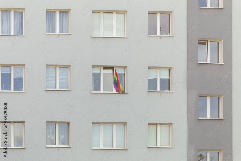 The LGBT flag hangs on the window