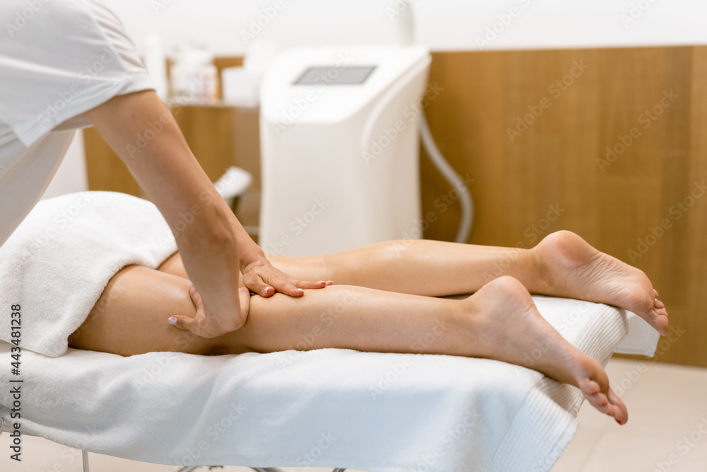 Fototapeta premium Middle-aged woman having a leg massage in a beauty salon.