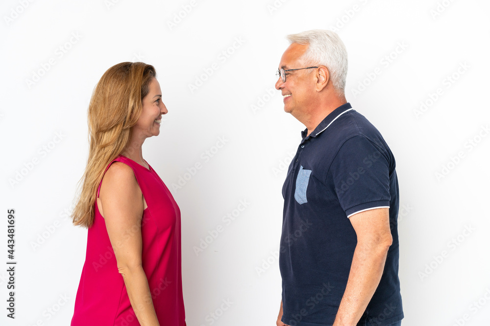 Middle age couple isolated on white background looking at each other Middle age couple isolated on white background looking at each other