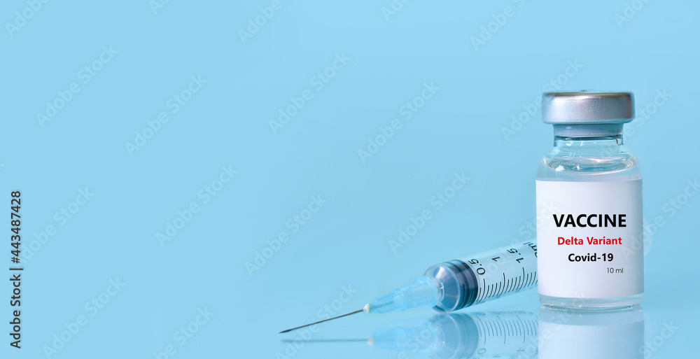 Vaccine in a bottle with a syringe on a blue background.The concept of medicine, healthcare and science.Coronavirus vaccine.Copy space for text.Banner Vaccine in a bottle with a syringe on a blue background.The concept of medicine, healthcare and science.Coronavirus vaccine.Copy space for text.Banner