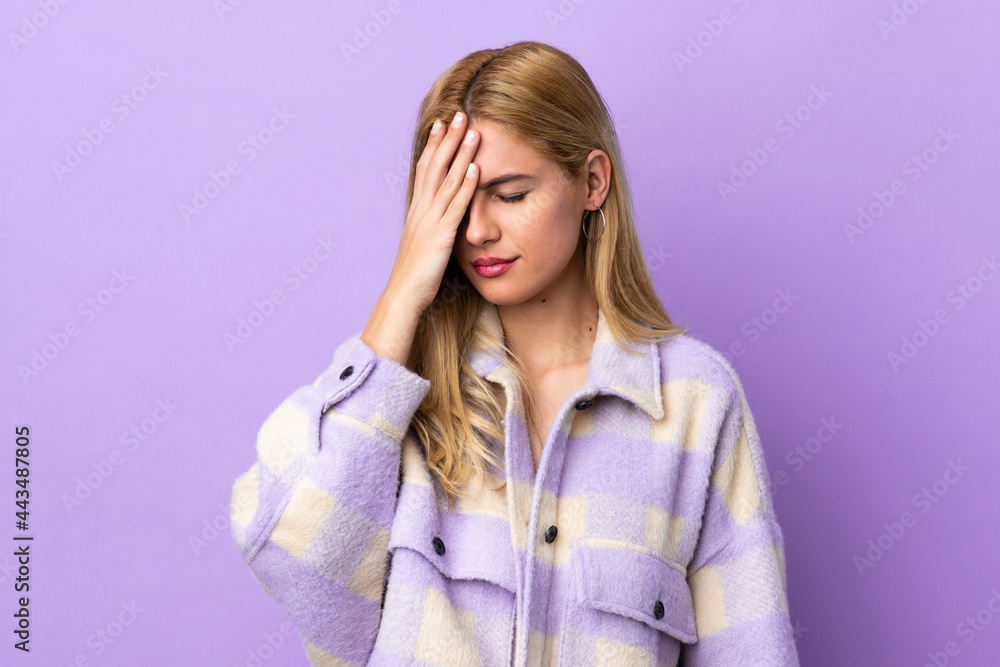 Young Uruguayan blonde woman over isolated background with headache Young Uruguayan blonde woman over isolated background with headache